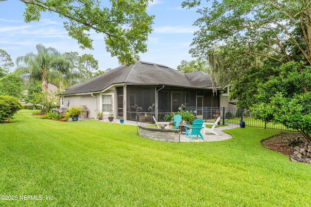 1758 Country Walk Dr, Fleming Island, FL 32003 - back of property with a sunroom, a patio area, roof with shingles, and an outdoor fire pit