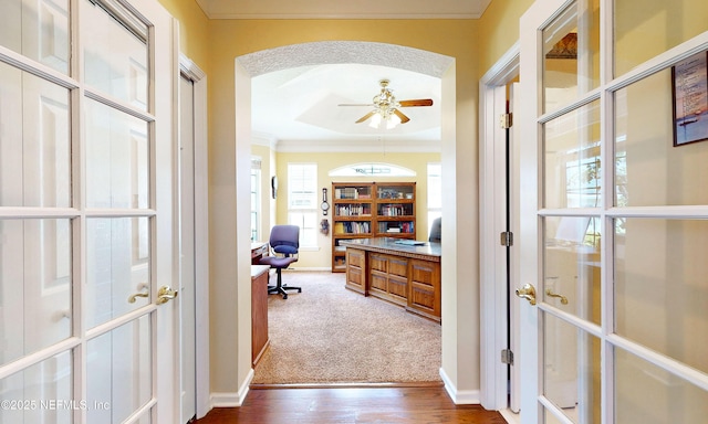 1700 Waters Edge Dr, Fleming Island, FL 32003 - hall featuring crown molding, an office area, arched walkways, baseboards, and dark wood-style floors