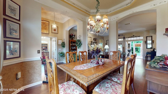 1700 Waters Edge Dr, Fleming Island, FL 32003 - dining room featuring wood-type flooring, arched walkways, a chandelier, and crown molding