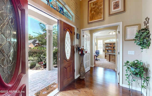 1700 Waters Edge Dr, Fleming Island, FL 32003 - foyer with baseboards, arched walkways, and wood finished floors