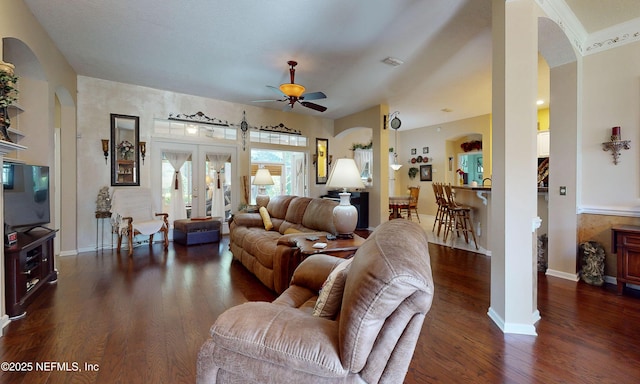1700 Waters Edge Dr, Fleming Island, FL 32003 - living area with arched walkways, ceiling fan, dark wood finished floors, and baseboards