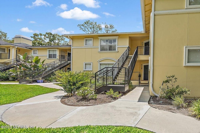 1800 The Greens Way Unit 1907, Jacksonville Beach, FL 32250 - view of building exterior featuring stairway