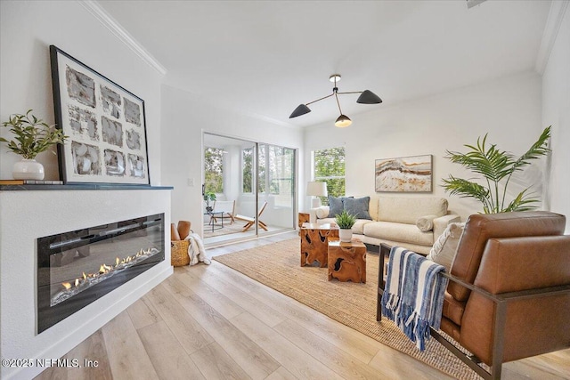 1800 The Greens Way Unit 1907, Jacksonville Beach, FL 32250 - living area featuring wood finished floors, a glass covered fireplace, ceiling fan, ornamental molding, and baseboards