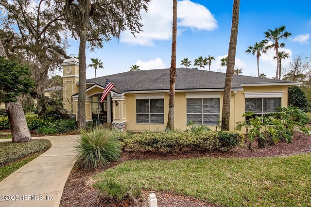 1800 The Greens Way Unit 1907, Jacksonville Beach, FL 32250 - view of front of house with stucco siding and a shingled roof