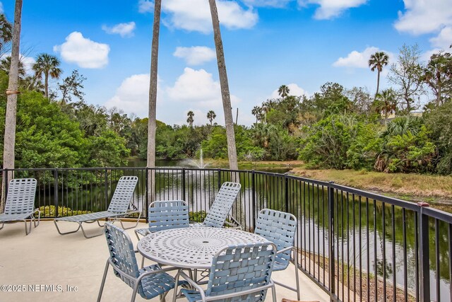1800 The Greens Way Unit 1907, Jacksonville Beach, FL 32250 - view of patio / terrace with view of wooded area and a water view