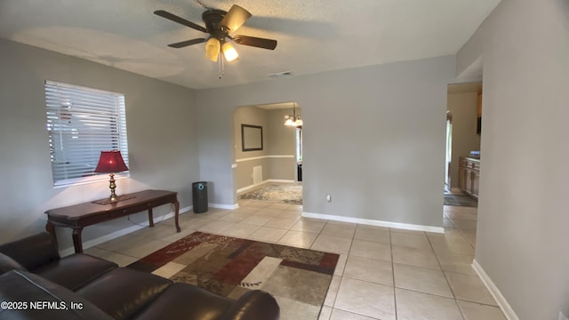5923 Green Hill Ln, Jacksonville, FL 32211 - living area with tile patterned flooring, arched walkways, ceiling fan, a chandelier, and baseboards