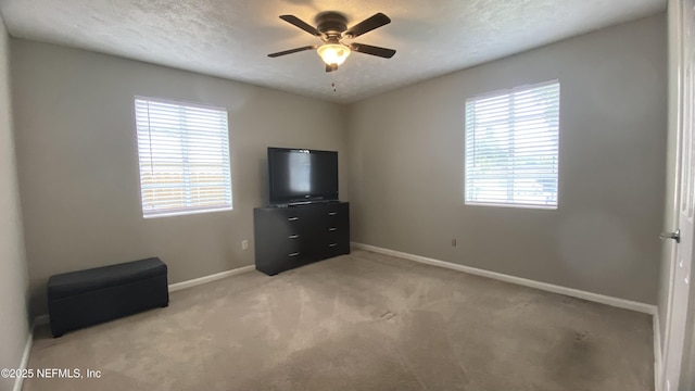 5923 Green Hill Ln, Jacksonville, FL 32211 - unfurnished bedroom with baseboards, carpet, a textured ceiling, and ceiling fan