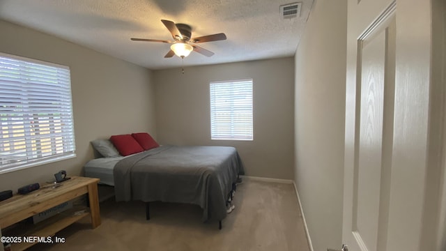 5923 Green Hill Ln, Jacksonville, FL 32211 - bedroom with a textured ceiling, light colored carpet, baseboards, and a ceiling fan