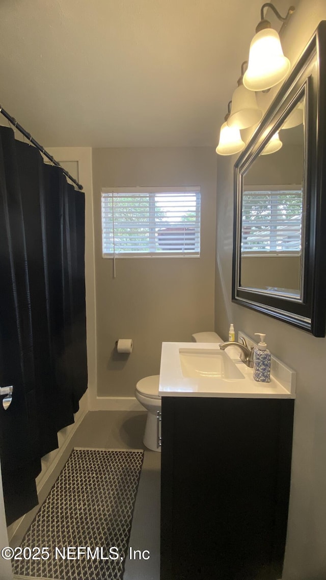 5923 Green Hill Ln, Jacksonville, FL 32211 - full bathroom featuring vanity, toilet, a shower with curtain, and tile patterned flooring