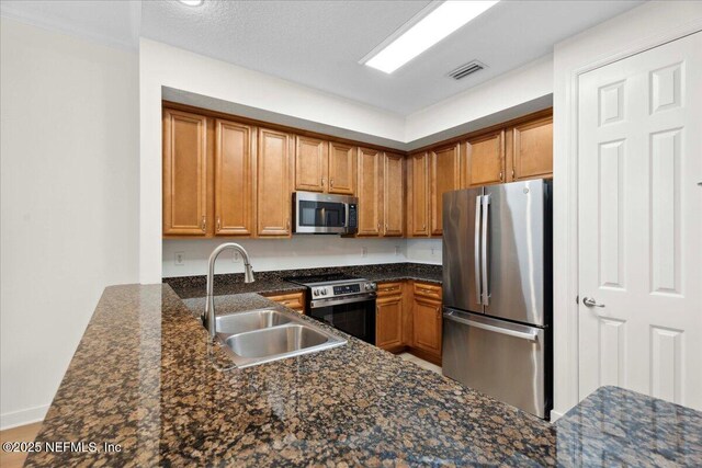 150 Pantano Cay Blvd Unit 2303, Saint Augustine, FL 32080 - kitchen featuring appliances with stainless steel finishes, brown cabinets, and dark stone countertops