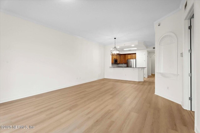150 Pantano Cay Blvd Unit 2303, Saint Augustine, FL 32080 - unfurnished living room with light wood-type flooring, a chandelier, and crown molding