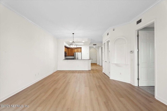 150 Pantano Cay Blvd Unit 2303, Saint Augustine, FL 32080 - unfurnished living room with crown molding, light wood-type flooring, and a chandelier