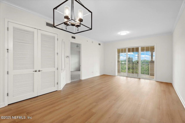 150 Pantano Cay Blvd Unit 2303, Saint Augustine, FL 32080 - unfurnished dining area with ornamental molding, light wood-style floors, and a chandelier