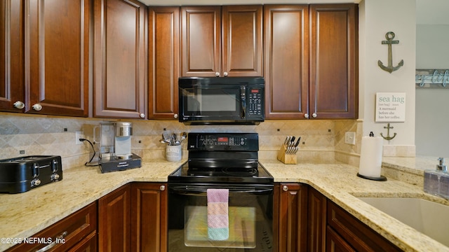 87 Village Del Lago Cir, Saint Augustine, FL 32080 - kitchen featuring black appliances, tasteful backsplash, light stone countertops, and a sink