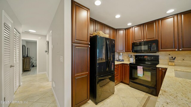87 Village Del Lago Cir, Saint Augustine, FL 32080 - kitchen with black appliances, light tile patterned floors, backsplash, light stone counters, and recessed lighting