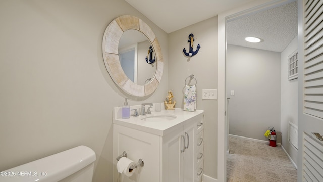 87 Village Del Lago Cir, Saint Augustine, FL 32080 - bathroom with vanity, toilet, baseboards, and a textured ceiling