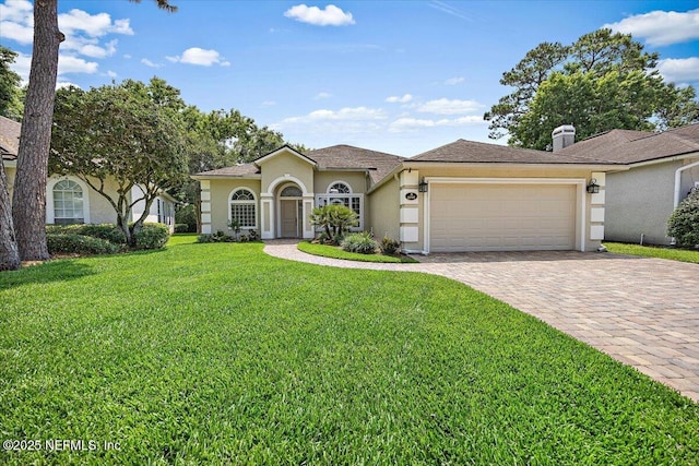 6541 Burnham Cir, Ponte Vedra Beach, FL 32082 - mediterranean / spanish home with a garage, a front lawn, driveway, and stucco siding