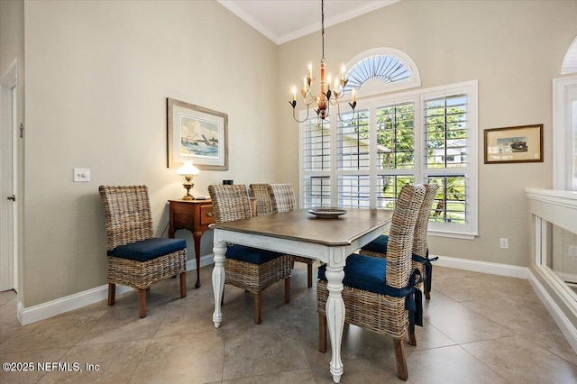 6541 Burnham Cir, Ponte Vedra Beach, FL 32082 - dining space featuring ornamental molding, a chandelier, a high ceiling, baseboards, and healthy amount of natural light