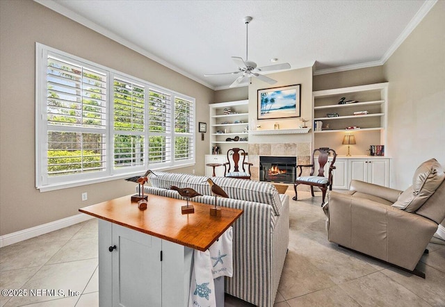 6541 Burnham Cir, Ponte Vedra Beach, FL 32082 - living room featuring crown molding, a tile fireplace, ceiling fan, built in shelves, and baseboards