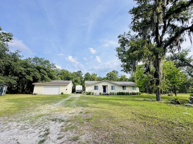417 2nd Ave, Satsuma, FL 32189 - view of green lawn with an outdoor structure, a detached garage, and view of scattered trees