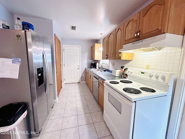 417 2nd Ave, Satsuma, FL 32189 - kitchen with stainless steel appliances, under cabinet range hood, backsplash, light tile patterned flooring, and a sink