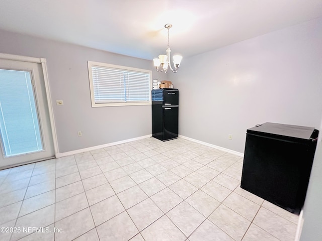 417 2nd Ave, Satsuma, FL 32189 - unfurnished room with a chandelier, light tile patterned flooring, and baseboards