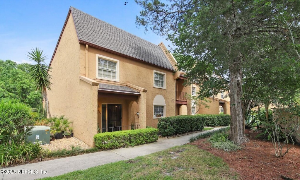 407 Abingdon Pl Unit 84, Jacksonville, FL 32225 - view of front of house with stucco siding and a shingled roof