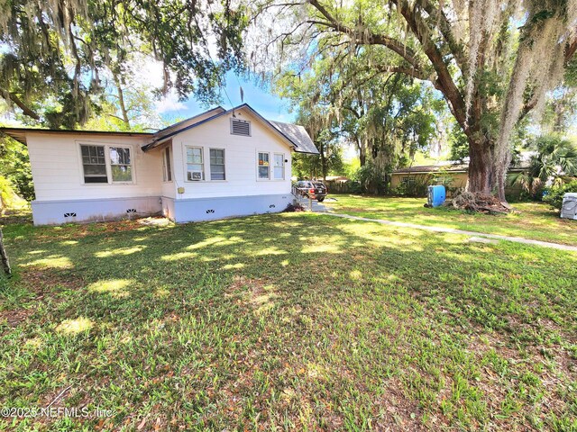 8726 6th Ave, Jacksonville, FL 32208 - view of home's exterior featuring crawl space and a yard