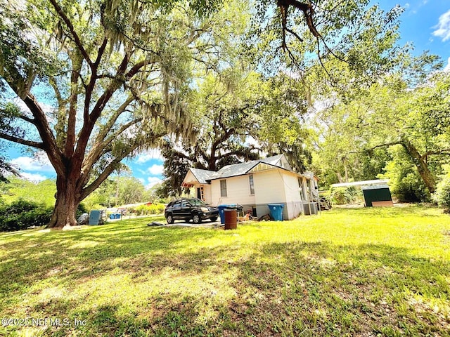 8726 6th Ave, Jacksonville, FL 32208 - view of green lawn with central AC unit