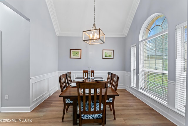 1321 Honeysuckle Dr, Saint Johns, FL 32259 - dining space with ornamental molding, a chandelier, a wainscoted wall, and light wood-style flooring