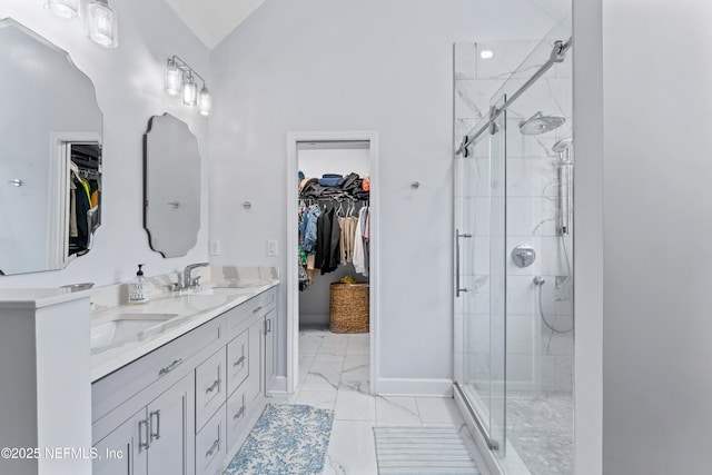1321 Honeysuckle Dr, Saint Johns, FL 32259 - bathroom featuring marble look tile flooring, double vanity, a spacious closet, a stall shower, and baseboards