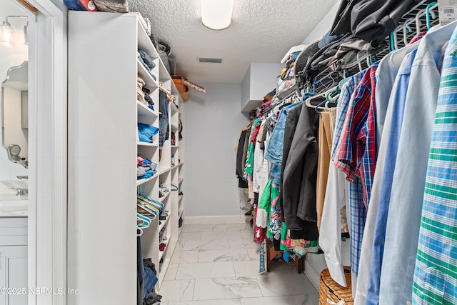 1321 Honeysuckle Dr, Saint Johns, FL 32259 - walk in closet featuring marble look tile flooring and a sink