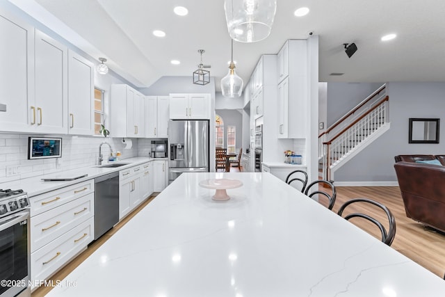 1321 Honeysuckle Dr, Saint Johns, FL 32259 - kitchen with stainless steel appliances, a sink, backsplash, white cabinetry, and recessed lighting