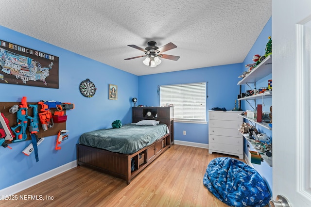 1321 Honeysuckle Dr, Saint Johns, FL 32259 - bedroom with wood finished floors, a textured ceiling, baseboards, and a ceiling fan