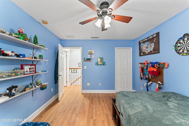 1321 Honeysuckle Dr, Saint Johns, FL 32259 - bedroom featuring light wood-style floors, a textured ceiling, baseboards, a closet, and a ceiling fan