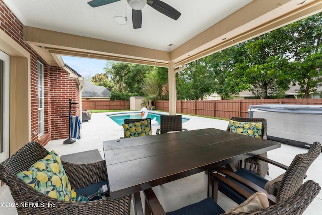 1321 Honeysuckle Dr, Saint Johns, FL 32259 - fenced backyard featuring a hot tub, outdoor dining area, ceiling fan, a patio area, and a storage unit