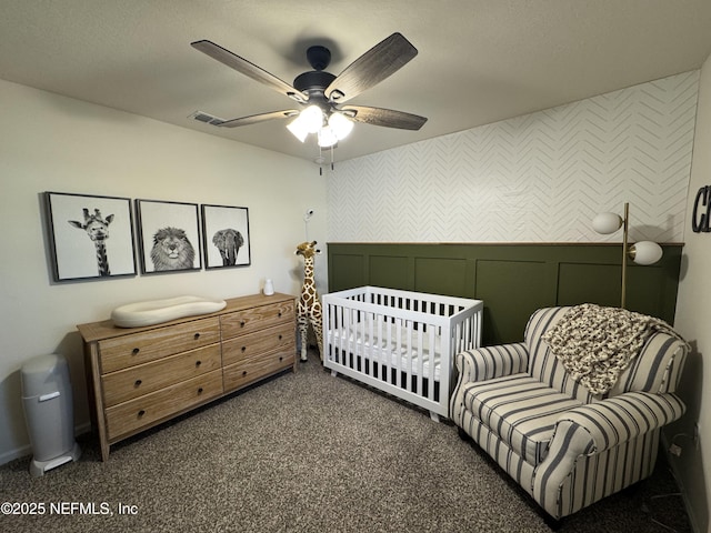 126 Falcon Ridge Rd, Saint Augustine, FL 32084 - carpeted bedroom featuring wallpapered walls, a ceiling fan, a decorative wall, and a nursery area