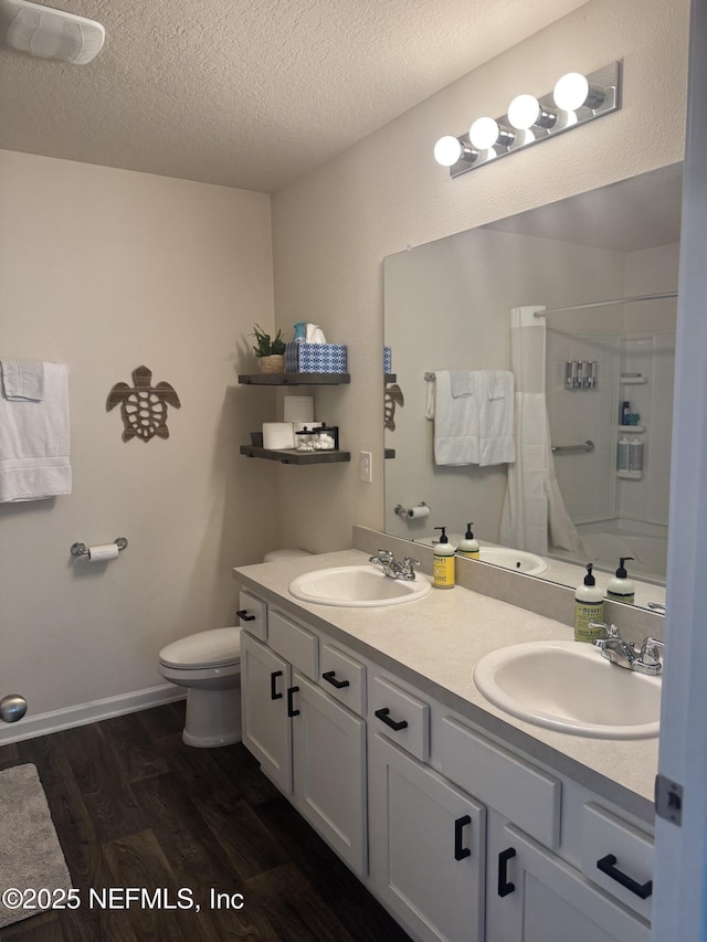 126 Falcon Ridge Rd, Saint Augustine, FL 32084 - full bath with double vanity, wood finished floors, a textured ceiling, and shower / bathtub combination with curtain