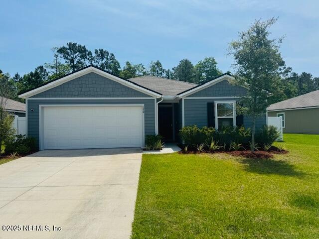 126 Falcon Ridge Rd, Saint Augustine, FL 32084 - single story home with driveway, a front lawn, and a garage