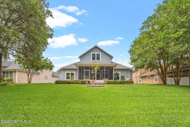 8681 Canopy Oaks Dr, Jacksonville, FL 32256 - view of front of property featuring a sunroom, a front lawn, and stucco siding