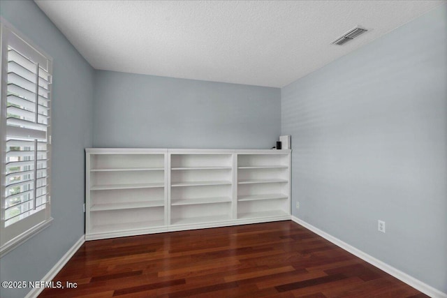 8681 Canopy Oaks Dr, Jacksonville, FL 32256 - spare room featuring wood finished floors, a textured ceiling, and baseboards