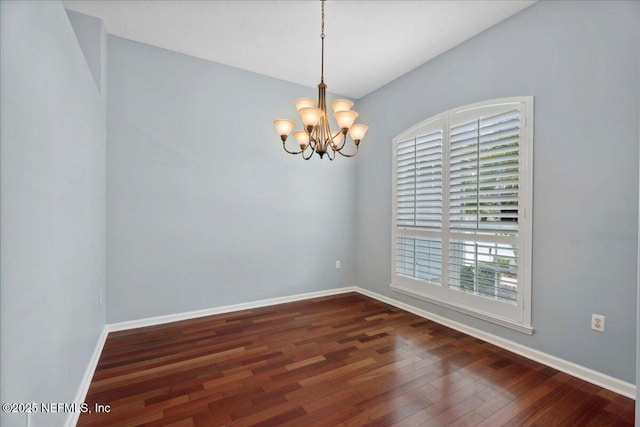 8681 Canopy Oaks Dr, Jacksonville, FL 32256 - unfurnished room featuring dark wood-type flooring, a chandelier, and baseboards