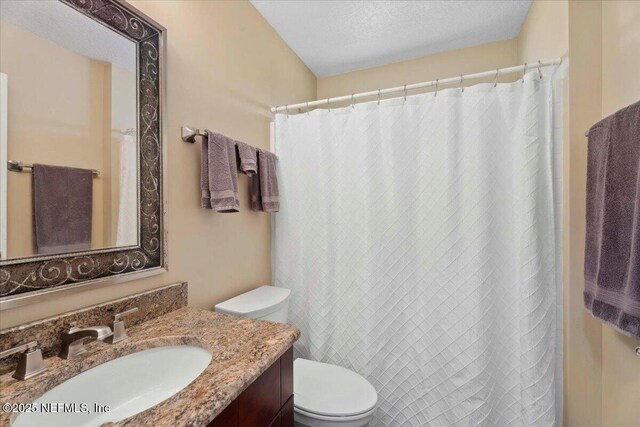 8681 Canopy Oaks Dr, Jacksonville, FL 32256 - full bathroom with vanity, toilet, a textured ceiling, and curtained shower
