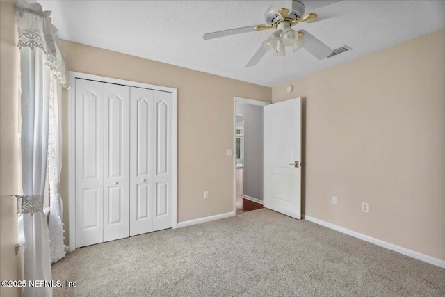 8681 Canopy Oaks Dr, Jacksonville, FL 32256 - unfurnished bedroom featuring carpet flooring, a closet, baseboards, and a ceiling fan