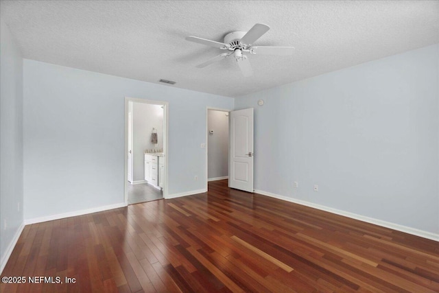 8681 Canopy Oaks Dr, Jacksonville, FL 32256 - unfurnished bedroom featuring wood-type flooring, a textured ceiling, baseboards, and ensuite bath