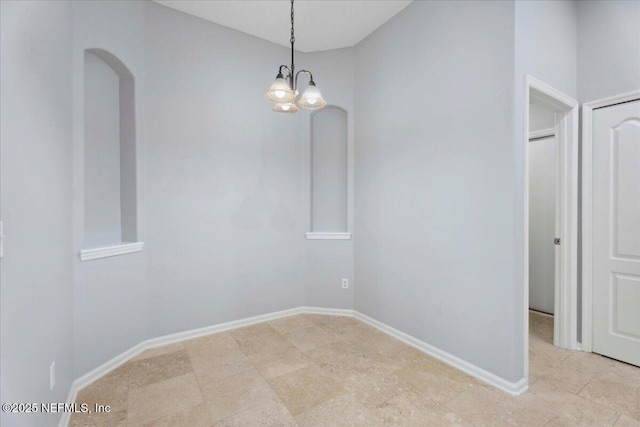 8681 Canopy Oaks Dr, Jacksonville, FL 32256 - unfurnished dining area featuring arched walkways, baseboards, and a chandelier