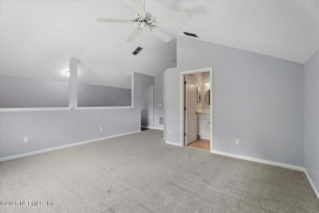 8681 Canopy Oaks Dr, Jacksonville, FL 32256 - unfurnished bedroom with carpet, vaulted ceiling, baseboards, ensuite bath, and ceiling fan