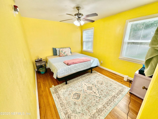 1966 Lakewood Cir S, Jacksonville, FL 32207 - bedroom with multiple windows, wood finished floors, a ceiling fan, and baseboards