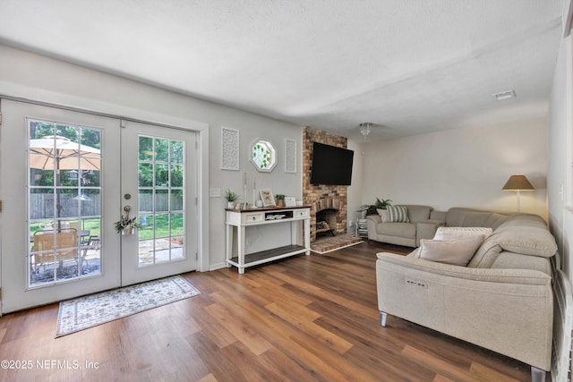 2620 Shenandoah Dr S, Orange Park, FL 32073 - living area with dark wood-type flooring, french doors, and a large fireplace
