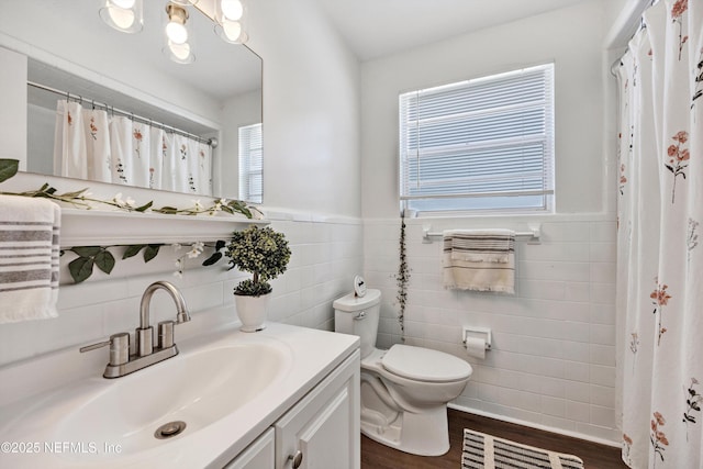 2620 Shenandoah Dr S, Orange Park, FL 32073 - bathroom featuring tile walls, wood finished floors, toilet, vanity, and a wainscoted wall